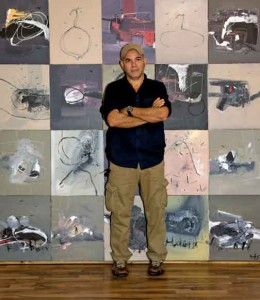 Artist Danilo González at his studio. Background: Exterior 1, 2010, acrylic on canvas. 